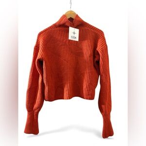 SEEK THE LABEL Cropped Waist Turtleneck knit Sweater in a rust/orange .
Size XS
